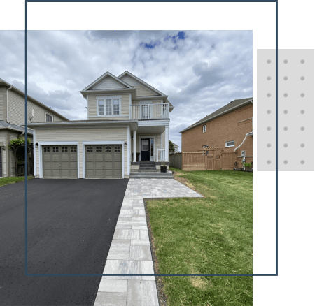 A house with two garage doors and grass in front of it.