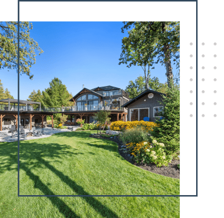 A picture of a house with many flowers in the yard.