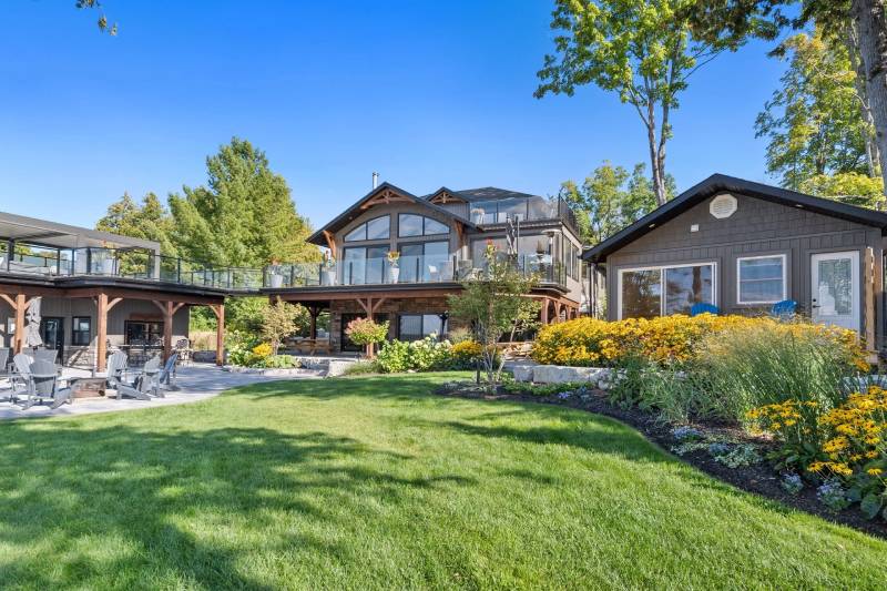 A large yard with grass and trees in the background